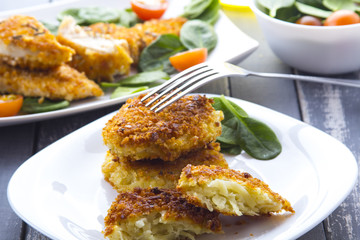 Food fried breading chicken spinach salad tomatoes pancakes from potatoes
