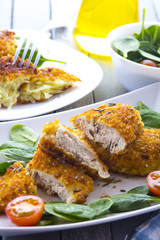 Food fried breading chicken spinach salad tomatoes pancakes from potatoes
