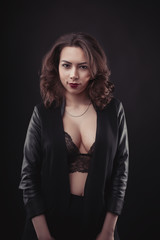 Seductive model in lace underwear and  jacket on her shoulders
