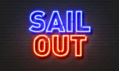 Sail out neon sign on brick wall background.