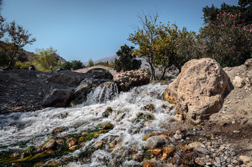 Small waterfall and old arch on a background in Preveli, Crete island