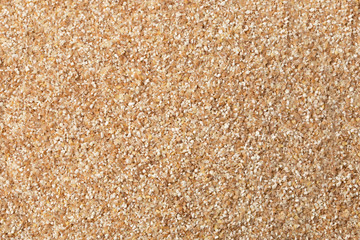 texture of raw wheat grits background. flat lay.