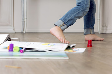 Child feet are on a background of the set to paint.. Stops of little girl. 