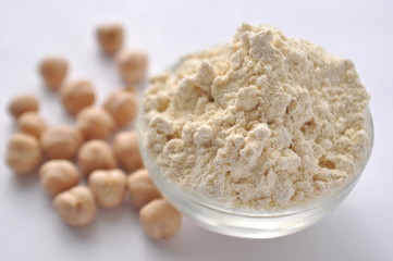 Chickpea flour and chickpeas isolated on white. Alternative gluten-free flour for baking and cooking. 
