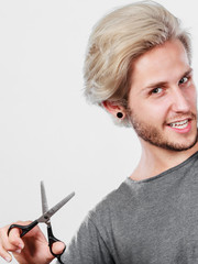 Man with scissors texturizing or thinning shears