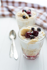 Healthy breakfast. Oatmeal with bananas, berries and honey