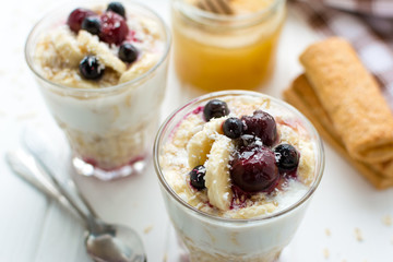 Healthy breakfast. Oatmeal with bananas, berries and honey