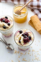 Healthy breakfast. Oatmeal with bananas, berries and honey