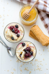 Healthy breakfast. Oatmeal with bananas, berries and honey