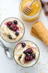 Healthy breakfast. Oatmeal with bananas, berries and honey