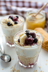 Healthy breakfast. Oatmeal with bananas, berries and honey