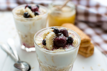 Healthy breakfast. Oatmeal with bananas, berries and honey