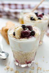 Healthy breakfast. Oatmeal with bananas, berries and honey