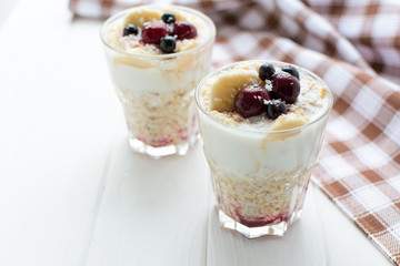 Healthy breakfast. Oatmeal with bananas, berries and honey