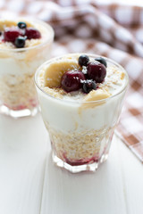 Healthy breakfast. Oatmeal with bananas, berries and honey