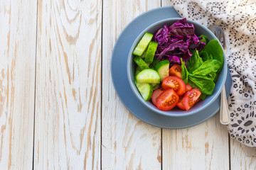 Green salad with  tomato, red cabbage, cucumber and spinach