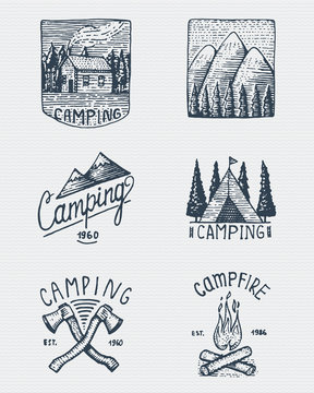 set of engraved vintage, hand drawn, old, labels or badges for camping, hiking, hunting with mountain peaks, house, axe and tent, campfire with forest