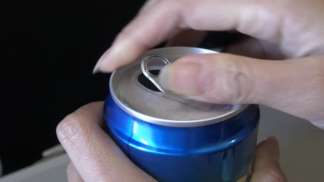 4k closeup the hand of the passenger woman opening a beverage can in the Interior airplane during flight-Dan
