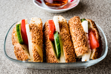 Turkish Bagel Simit Sandwich with cheese, tomato, cucumber and tea.