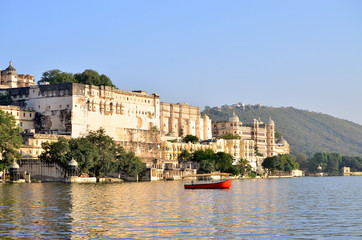 Beautiful landscape of the city on water at sunset in India Udaipur
