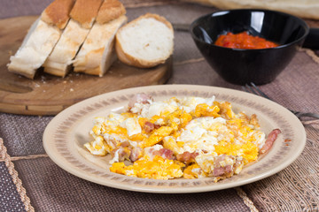 Fried eggs with bacon served on the table
