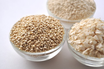 Quinoa in three forms - flour, flakes and grain. Alternative gluten-free grain. Isolated on white
