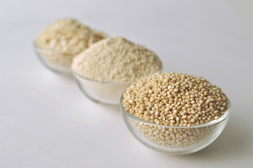 Quinoa in three forms - flour, flakes and grain. Alternative gluten-free grain. Isolated on white
