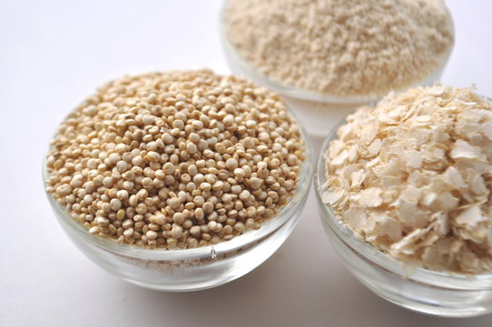 Quinoa in three forms - flour, flakes and grain. Alternative gluten-free grain. Isolated on white
