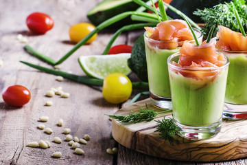 Appetizer with salted salmon and avocado with green onion, selective focus