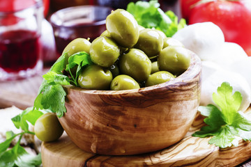 Green olives, cheese, tomatoes and wine, still life, selective focus
