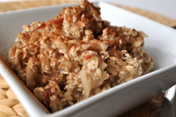 Healthy breakfast - oat flakes with grated apple and mashed banana sprinkled with cinnamon
