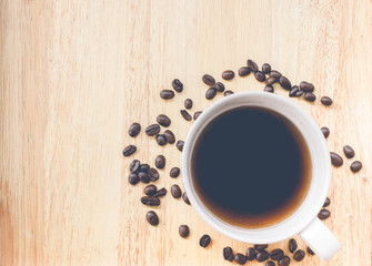 coffee bean and coffee mug on wood background