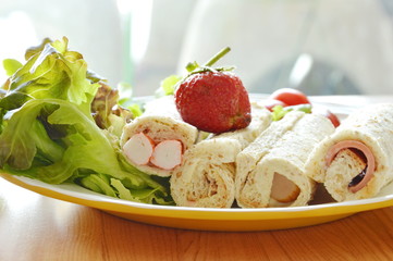 bread roll and salad topping strawberry on plate