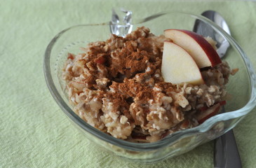 Healthy breakfast - oat flakes with grated apple and mashed banana sprinkled with cinnamon
