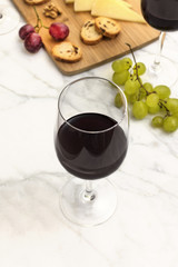 Wine tasting with bread, grapes, cheese, and copyspace