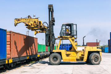 Obraz premium Forklift handling container box loading at the Docks with Truck