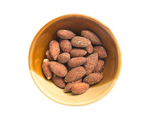 Almonds in bowl isolated on white background.
