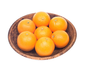 Ripe juicy organic oranges in wooden bowl isolated on white background