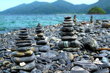 Many beauty pebble on koh Hin Ngam Island near Kor Lipe Island, Andaman sea, Satun, Thailand with mountain and nice sea background