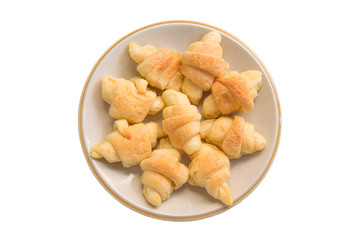 Mini croissants in plate isolated on white background.