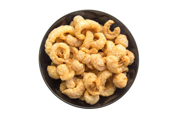 Pile of pork rind in bowl isolated on white background.