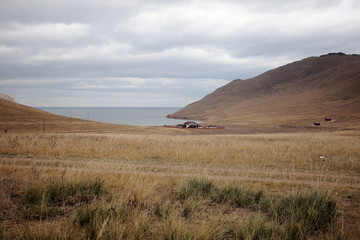 Guest house in Tazheranskaya the steppes near the Baikal lake Western shore of the lake, a small Bay, HOMESTEAD accommodation, steppe road, cloudy October day