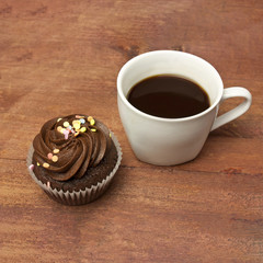 Cup of black coffee with chocolate cupcake, with copyspace