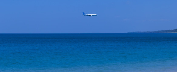Fototapeta na wymiar Airplane above sea