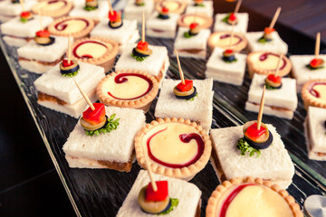 Bakery and dessert buffet laid on glass shelf.