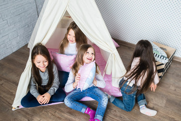 Child playing with a teepee