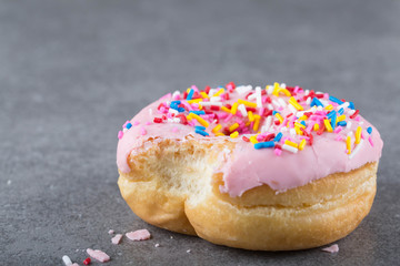 A donut with rainbow sprinkles. 