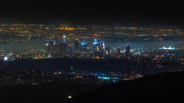 Timelapse of Los Angeles Skyline at night in Storm Clouds -Pan Left-
