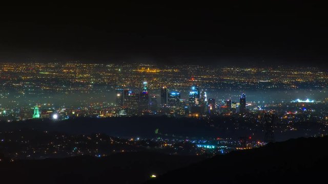 Timelapse of Los Angeles Skyline at night in Storm Clouds -Zoom In-