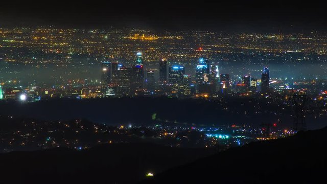 Timelapse of Los Angeles Skyline at night in Storm Clouds -Zoom Out-